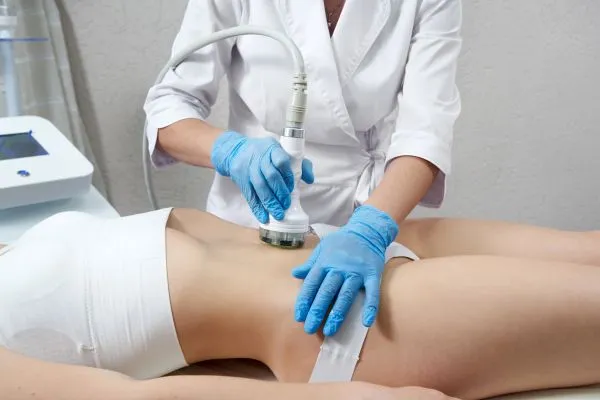 Lost the Weight but Not the Loose Skin? 2 woman having HIFU treatment on her stomach to combat loose skin Stratford following weight loss